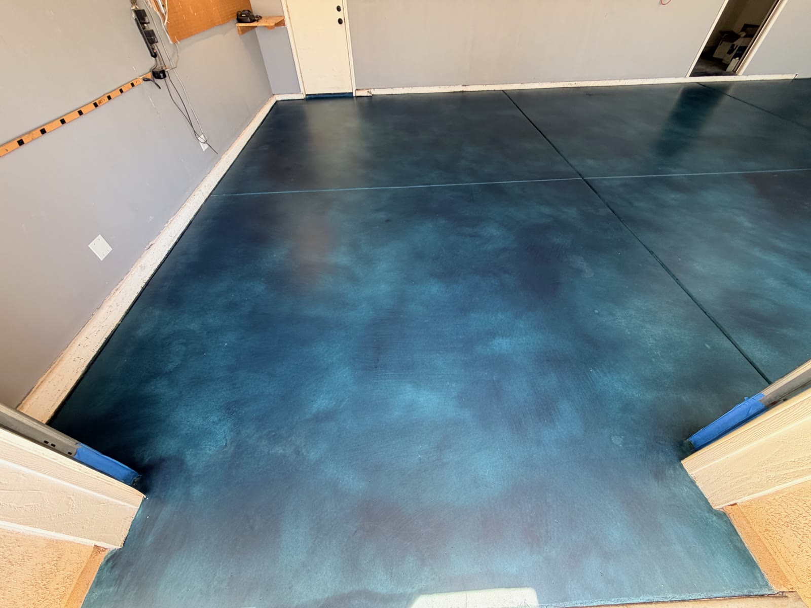 Blue acid-stained and sealed concrete garage floor in Valley Center